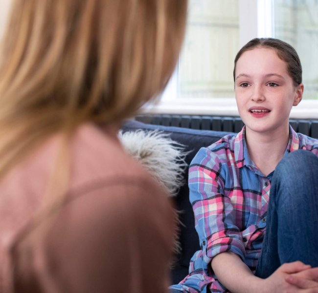 Mother Having Serious Conversation With Young Daughter At Home